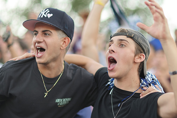 Father and son cheering at football game 