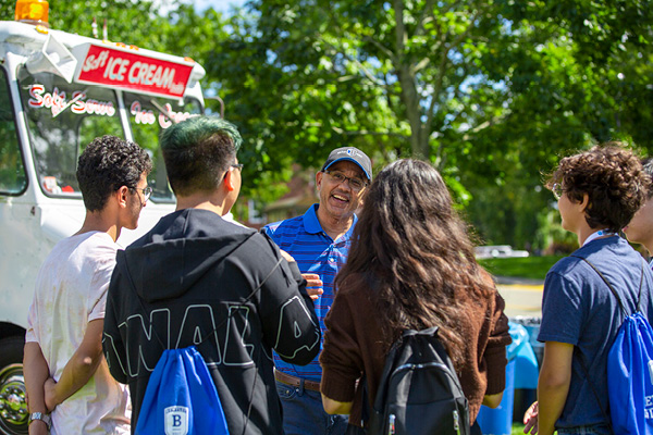 President Chrite with students gathered at an ice cream truck 