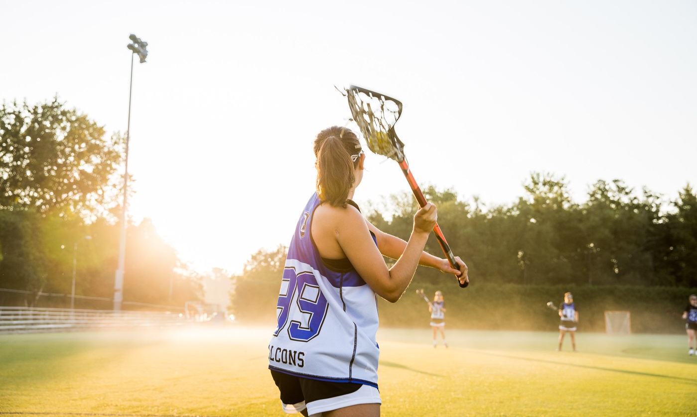 A Bentley University student plays lacrosse