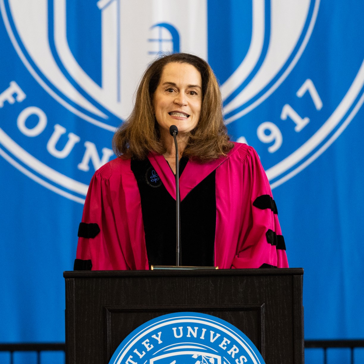 Trustee Deborah Spar stands at the podium to deliver her inauguration remarks