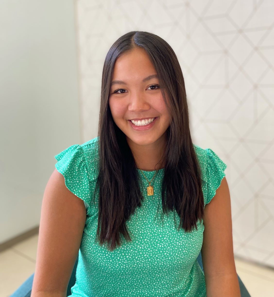 Banmai Huynh wearing a green blouse smiling