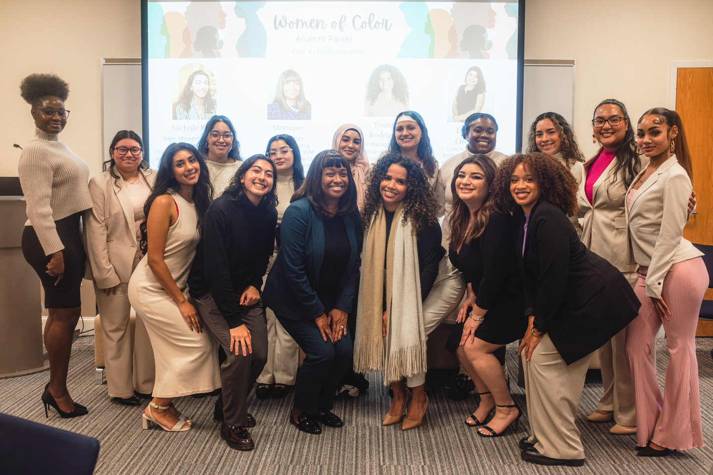 Members and alumnae of color from Bentley's Coming Full Circle group gather on stage during a panel event