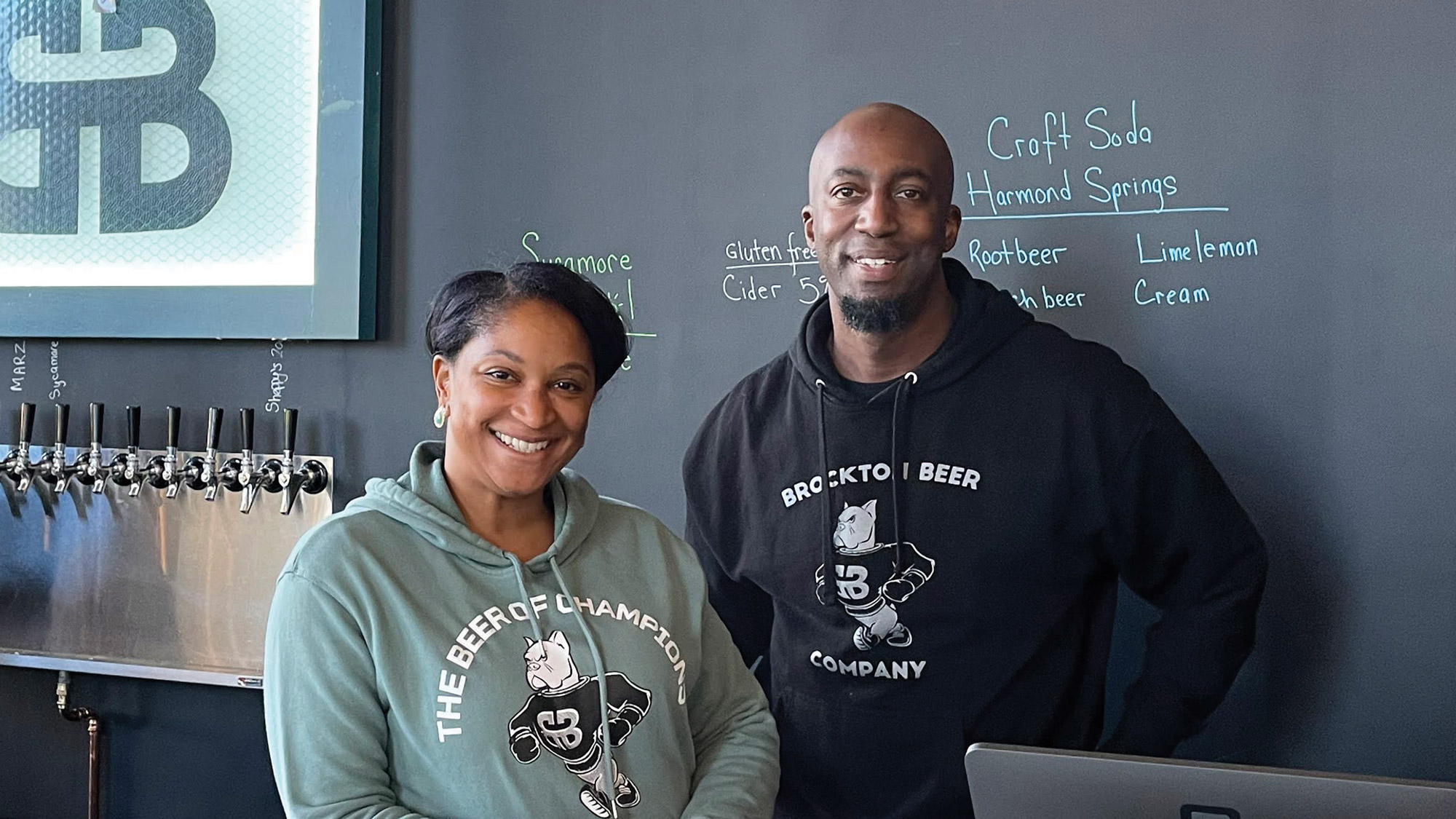 Eval ’99 and LaTisha (Stewart) ’99 Silvera smile behind the counter