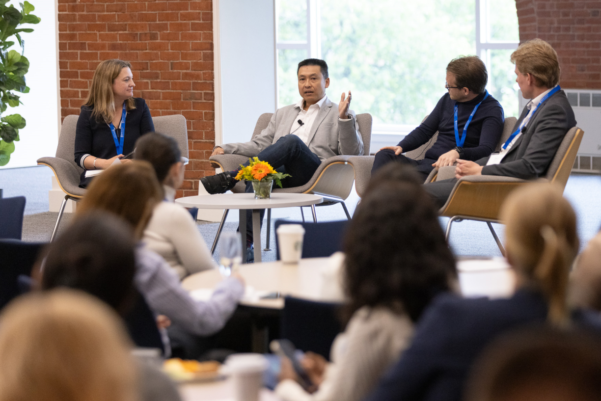 Attendees at the AI Summit listen intently to a panel discussion featuring (from left to right) Bentley professor Danielle Blanch Hartigan; Shwen Gwee, founder of Health Disruptors, Inc; Robert Maguire, founder and CEO of Altruistic AI; and Ronald Dorenbos, vice president of business development at Evotec.