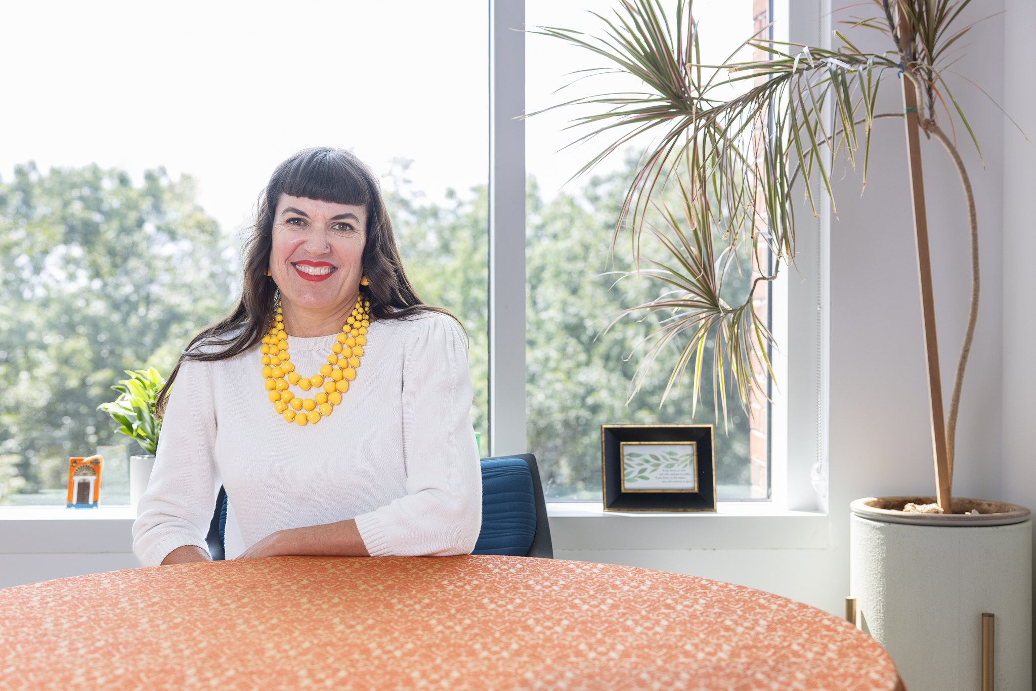 Jane Griffin in white shirt and yellow necklace