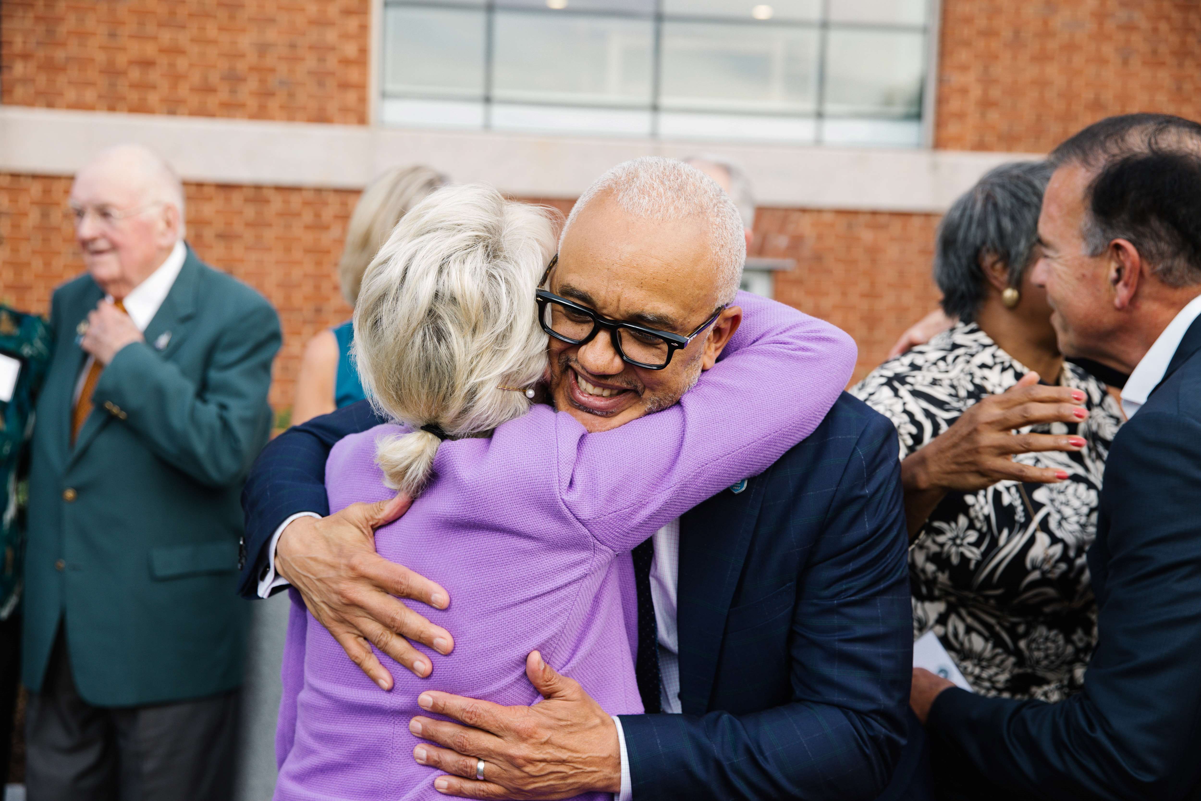 President Chrite and donor hug