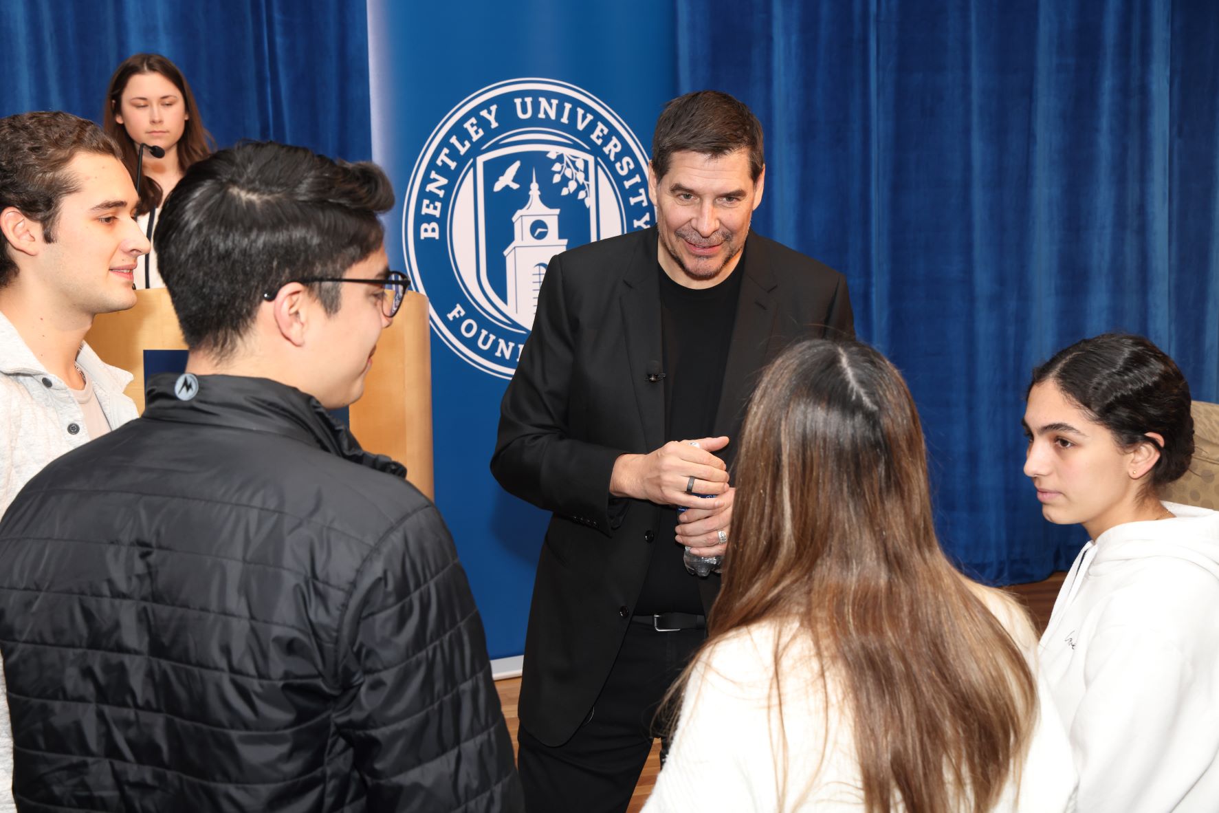 Marcelo Claure '93 conversing with Bentley students