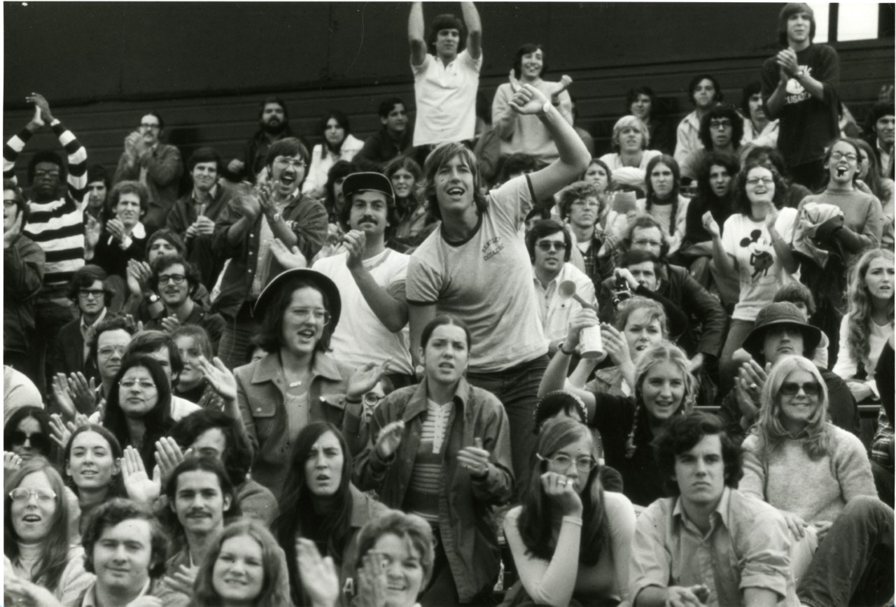 students cheer on Bentley in the stands at a school sporting event