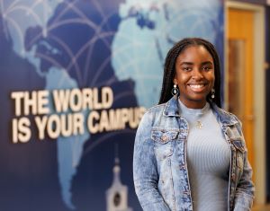 Pearl Opara in blue dress and denim jacket