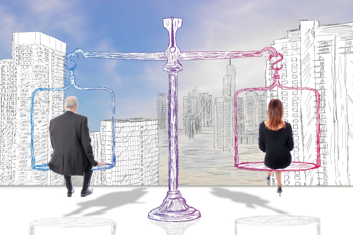 Photo illustration of oversized scale with a man and a woman sitting on either side. Their backs are turned, and they are looking out a city landscape filled with skyscrapers.