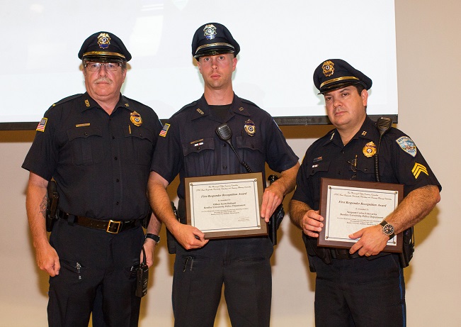 three police officers holding Certificates 