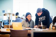 two students study in the library together