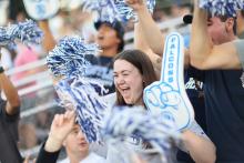 Excited female student at football game