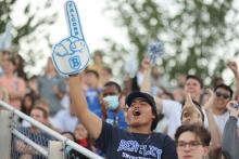 Male student with Football hand sign