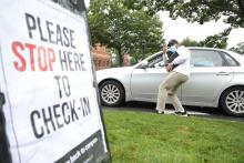 staffer directing cars on move in day 2021