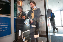 Student surrounded by fake dollar bills