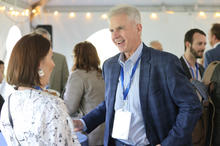 Man smiling and talking with a woman