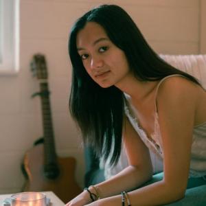 Bethany Barber sitting in front of a table with a candle