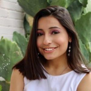 Headshot of Teresa Vielma, wearing a sleeveless lavender shirt