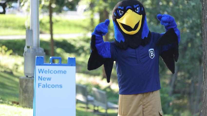 Flex the Falcon mascot with "welcome" sign