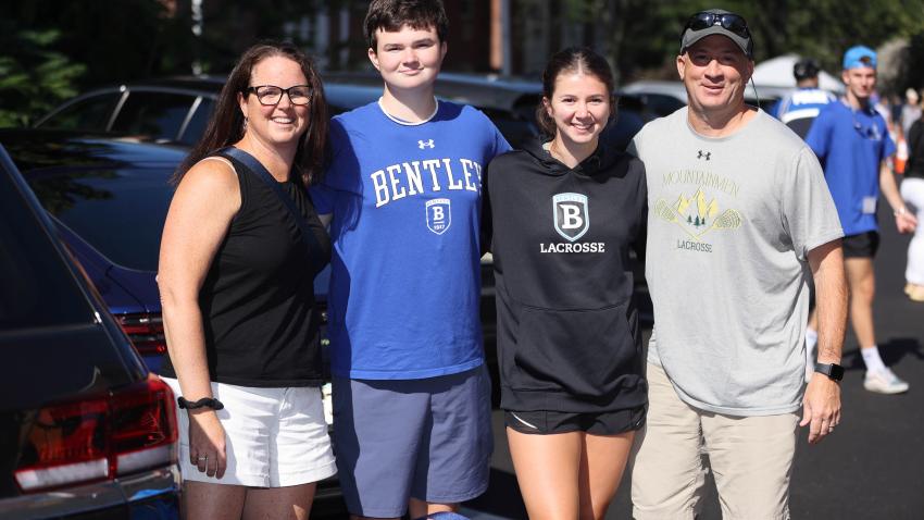 Three family members stand with incoming Bentley student