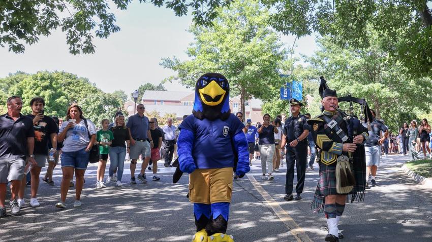 Bentley mascot Flex the Falcon leads a procession to the Class of 2028 convocation