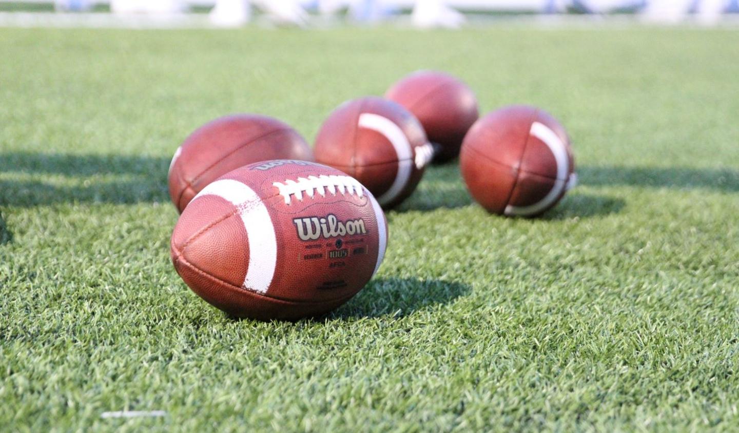 Footballs on the Bentley University field