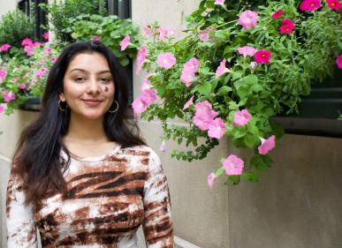 Medha Prakash in front of building with cascading flower boxes