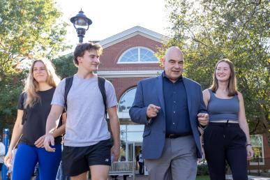 James “Pouli” Pouliopoulos walking and talking with Bentley students