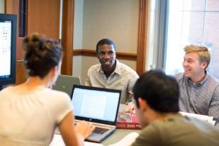 Students working together in a classroom around a table