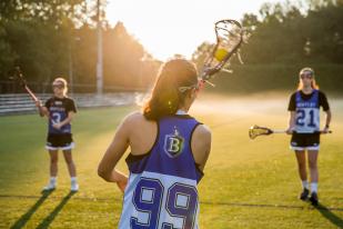 Image that depicts Bentley University women's lacrosse players. 